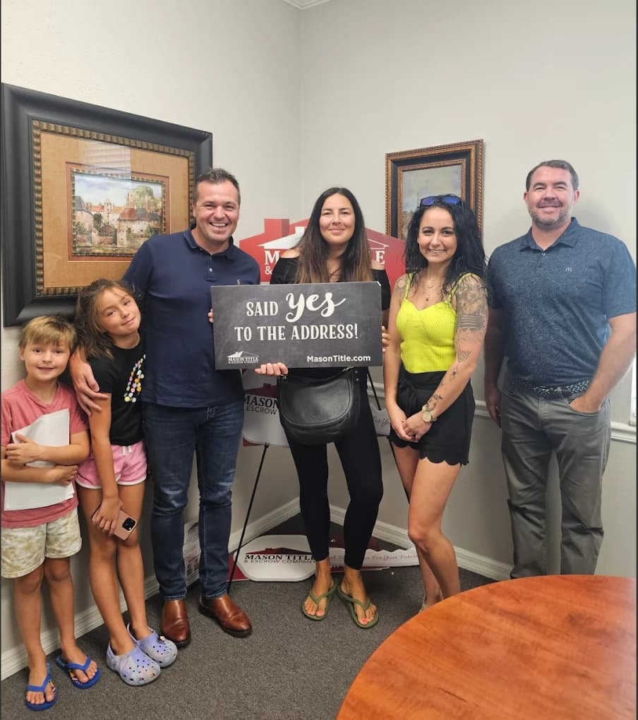 Family celebrating their home purchase at the closing table